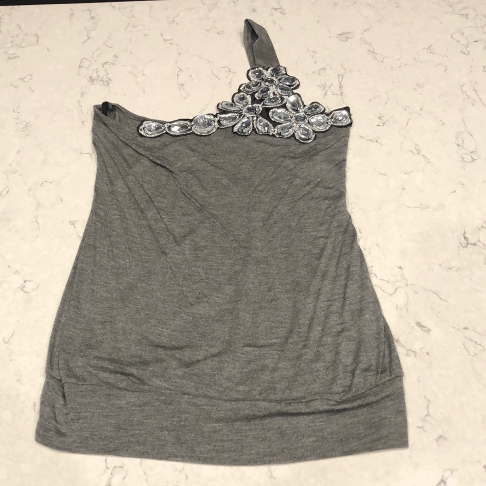 Flirty one sleeve blouse with eye catching bling. NWOT